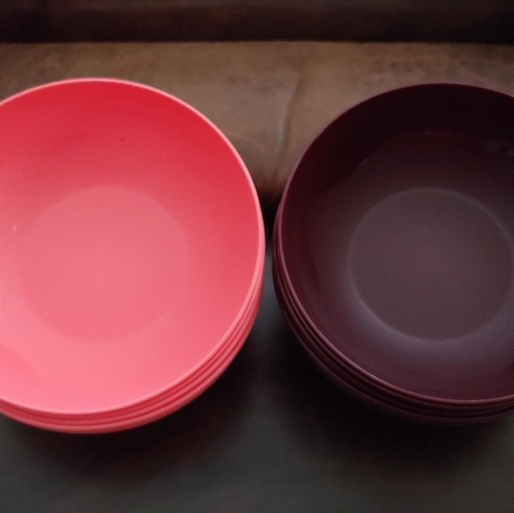 Two sets of four plastic bowls